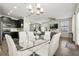 Open concept dining area offering a view to the kitchen and living room, and modern lighting at 11120 Whistling Pine Way, Orlando, FL 32832