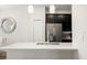 Kitchen view with stainless steel appliances, dark cabinetry, white countertops, and stylish mirror at 11120 Whistling Pine Way, Orlando, FL 32832