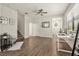 Open concept living area offers wood-look tile, ceiling fan, and flows to foyer, stairs and kitchen at 11120 Whistling Pine Way, Orlando, FL 32832
