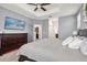 Relaxing main bedroom with tray ceiling, en suite bathroom, and mounted TV at 11120 Whistling Pine Way, Orlando, FL 32832