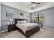 Relaxing main bedroom with tray ceiling, neutral paint, plush carpet, and a view of the trees at 11120 Whistling Pine Way, Orlando, FL 32832