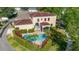 Aerial view of the home showcasing a beautiful pool, spa, and lush landscaping at 1116 Oak Pond Dr, Celebration, FL 34747