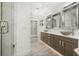 Modern bathroom showcasing double vanity, stone sinks, and frameless glass shower at 1116 Oak Pond Dr, Celebration, FL 34747