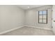 Empty bedroom features carpet, a window letting in light, and is painted neutral colors offering a blank canvas for a buyer at 1116 Oak Pond Dr, Celebration, FL 34747
