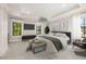 Modern bedroom with tray ceilings, plush carpeting, and large windows allowing for ample natural light at 1116 Oak Pond Dr, Celebration, FL 34747