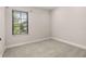 Neutral bedroom with carpet, a window letting in lots of light, and simple clean walls, a blank space to make your own at 1116 Oak Pond Dr, Celebration, FL 34747