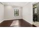 Bedroom with dark hardwood floors and view into a bathroom with glass tile at 1116 Oak Pond Dr, Celebration, FL 34747