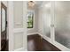 Hallway showing dark hardwood floors, custom millwork, and view to the outside through a window at 1116 Oak Pond Dr, Celebration, FL 34747