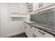 Functional laundry room featuring upper and lower cabinets, a stylish countertop, and a sink for added convenience at 1116 Oak Pond Dr, Celebration, FL 34747