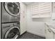 Efficient laundry area with a stacked washer/dryer, storage cabinets, and a sink providing convenience and organization at 1116 Oak Pond Dr, Celebration, FL 34747