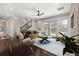 Comfortable living room with hardwood floors, a ceiling fan, a staircase, a stone wall, and glass doors to the patio at 1116 Oak Pond Dr, Celebration, FL 34747