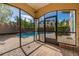 A screened-in patio provides expansive views of the pool, the backyard, and the surrounding tropical landscaping at 1116 Oak Pond Dr, Celebration, FL 34747