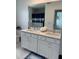Bathroom with double vanity, quartz countertop, and a large mirror at 11688 Founders St, Orlando, FL 32832