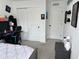 Bedroom features closet, desk with gaming setup, neutral carpet, and a calming aesthetic for sleep and relaxation at 11688 Founders St, Orlando, FL 32832