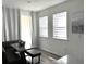 Bright breakfast nook features a gray leather bench with a white table and curtains at 11688 Founders St, Orlando, FL 32832