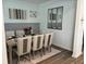 A beautifully staged dining room with seating for six and stylish decor, mirror on wall at 11688 Founders St, Orlando, FL 32832