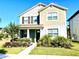 Charming two-story home with a manicured lawn and colorful flowerbeds lining the walkway at 11688 Founders St, Orlando, FL 32832