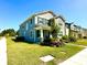 A beautifully landscaped two-story home features a charming front porch and well-maintained lawn at 11688 Founders St, Orlando, FL 32832