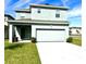 Two-story home with fresh lawn and attached two-car garage showing a well-maintained front yard at 11688 Founders St, Orlando, FL 32832