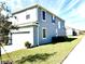 Two-story home with fresh lawn, attached two-car garage, a well-maintained lawn, and charming landscaping at 11688 Founders St, Orlando, FL 32832