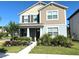 Charming two-story home with landscaped front yard and covered porch at 11688 Founders St, Orlando, FL 32832