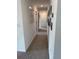 Long hallway with neutral carpet, light walls, and decorative art; ample lighting for a bright and inviting transition space at 11688 Founders St, Orlando, FL 32832