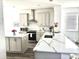 Bright, open kitchen featuring an island, stainless steel appliances, and quartz countertops at 11688 Founders St, Orlando, FL 32832
