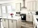 Bright, open kitchen featuring an island, stainless steel appliances, and quartz countertops at 11688 Founders St, Orlando, FL 32832