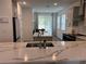 The kitchen offers stone countertops, stainless steel appliances, and a view to the dining area at 11688 Founders St, Orlando, FL 32832