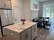 Modern kitchen with island, breakfast nook, and stainless steel refrigerator at 11688 Founders St, Orlando, FL 32832