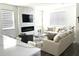 Cozy living room with a stone fireplace, TV, and comfortable seating with a view of bar at 11688 Founders St, Orlando, FL 32832