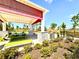 Open air pavilion with colorful picnic tables, benches, and beautiful landscaping is great for gatherings at 11688 Founders St, Orlando, FL 32832