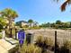 Community playground with climbing structure, bordered by manicured landscaping and lush palm trees at 11688 Founders St, Orlando, FL 32832