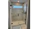 Modern bathroom features a glass-enclosed shower with a sleek shower head and horizontally-laid tile at 11688 Founders St, Orlando, FL 32832