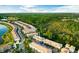 Aerial view of a residential community surrounded by lush greenery and a lake at 1231 Sandwedge St, Davenport, FL 33896