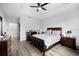 Bedroom featuring a neutral-colored comforter, wood-look floors and a ceiling fan at 1231 Sandwedge St, Davenport, FL 33896