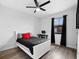 Bedroom with a ceiling fan, wood-look floors, desk and black out curtains at 1231 Sandwedge St, Davenport, FL 33896
