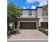 Charming two-story home with a two-car garage and lush landscaping at 1231 Sandwedge St, Davenport, FL 33896