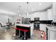 Modern kitchen featuring white cabinets, black backsplash, stainless steel appliances, and a center island with bar seating at 1231 Sandwedge St, Davenport, FL 33896