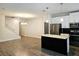 Modern kitchen with stainless steel appliances and a black brick island at 1231 Sandwedge St, Davenport, FL 33896