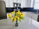 Bright kitchen with white cabinets, quartz countertops, and stainless steel appliances at 1231 Sandwedge St, Davenport, FL 33896