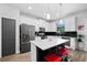 Updated kitchen featuring white cabinets, a black tiled backsplash, and an island with seating at 1231 Sandwedge St, Davenport, FL 33896