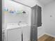 Laundry room featuring a washer, a dryer, overhead storage, and wood-look floors at 1231 Sandwedge St, Davenport, FL 33896