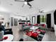 Open-concept living room with modern sofas, stylish rug, and a seamless flow into the kitchen at 1231 Sandwedge St, Davenport, FL 33896