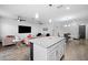 Spacious living room connected to the kitchen, featuring updated appliances and modern finishes at 1231 Sandwedge St, Davenport, FL 33896