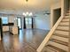 Spacious living room with tile floors, plenty of natural light, and stairs at 1231 Sandwedge St, Davenport, FL 33896
