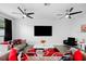 Spacious living room with modern furniture, a decorative rug, and ample natural light streaming through the windows at 1231 Sandwedge St, Davenport, FL 33896