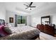 Bedroom features a tray ceiling, a large window, a dresser and wood-look floors at 1231 Sandwedge St, Davenport, FL 33896