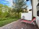 Private outdoor patio featuring brick pavers, lounge chairs, and a view of the green backyard at 1231 Sandwedge St, Davenport, FL 33896
