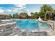 Beautiful community pool surrounded by palm trees and lounge area at 1231 Sandwedge St, Davenport, FL 33896